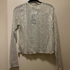 White top with silver sparkles. Never worn. Size 10